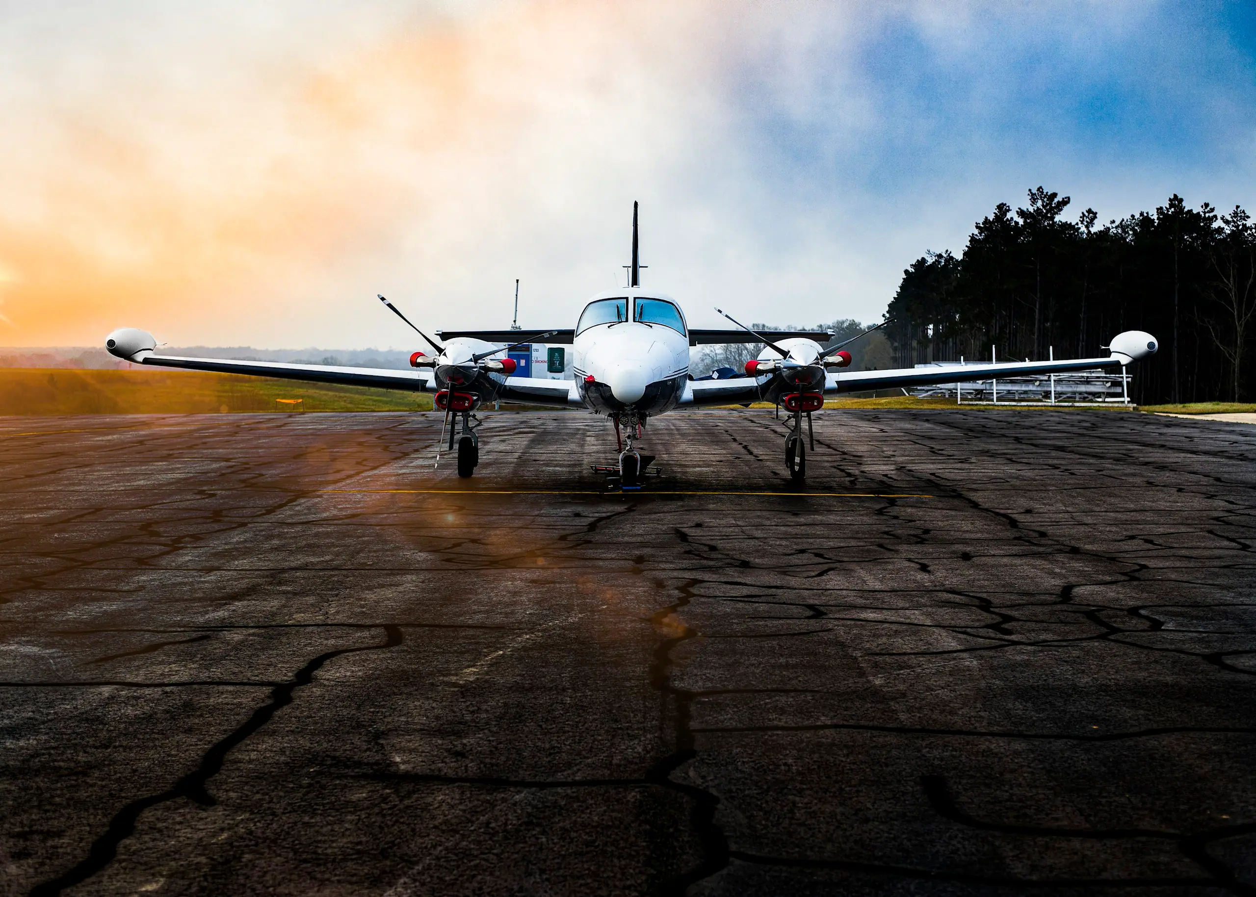 Twin turboprop on a runway at sunrise