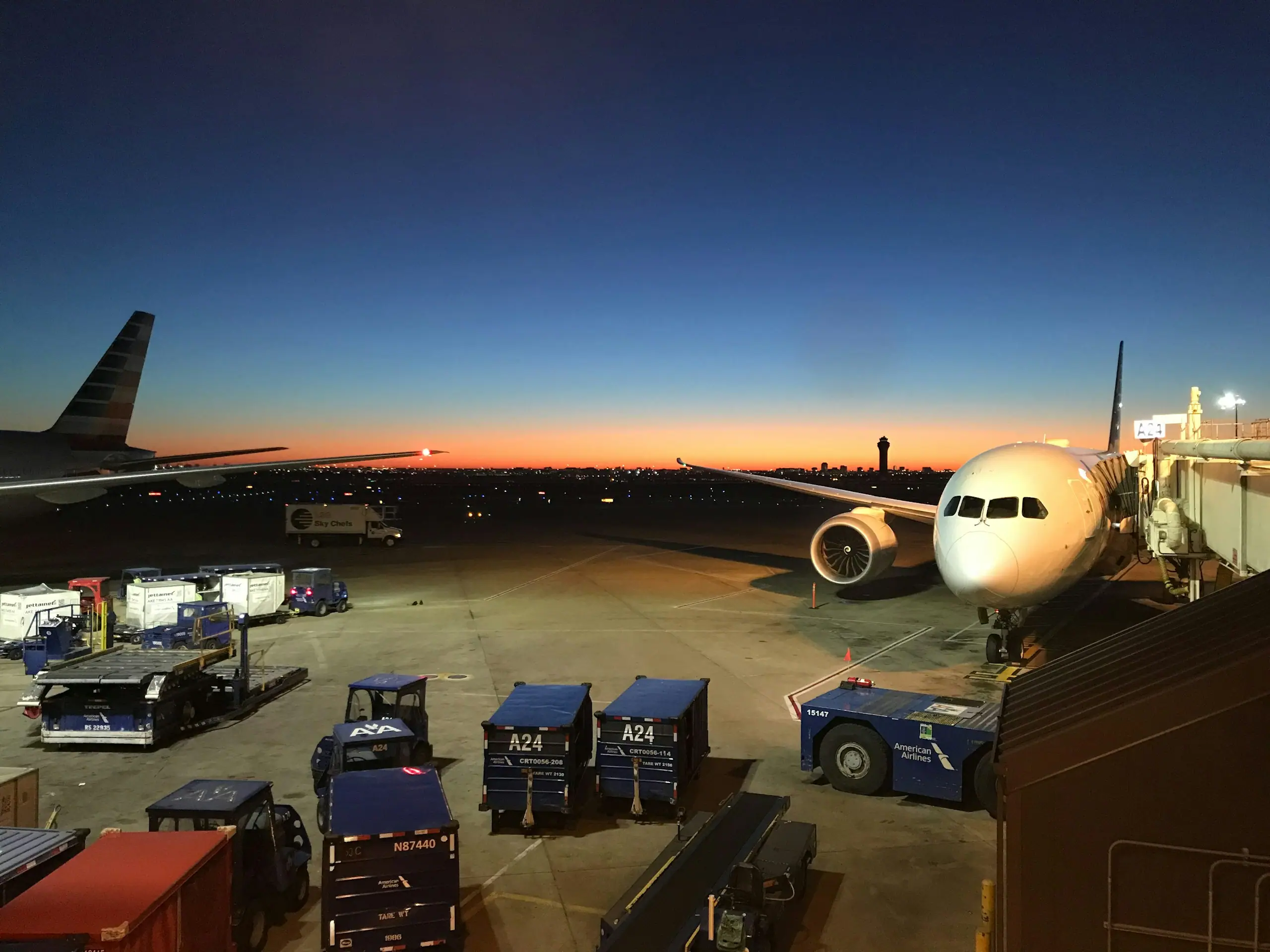 Cargo ramp at twilight with containers and ground equipment